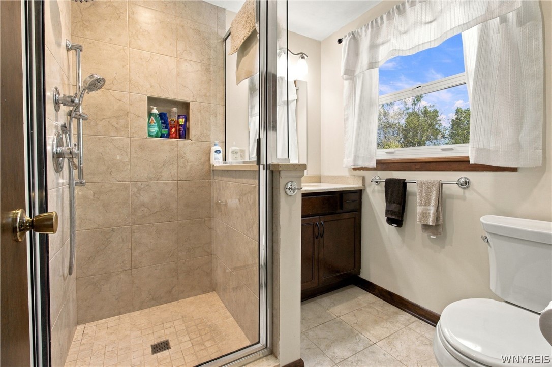 123 Ranch Trail West Amherst, NY 14221 - Photo 20 of 38 A tiled walk-in shower highlights this functional bathroom spaces.