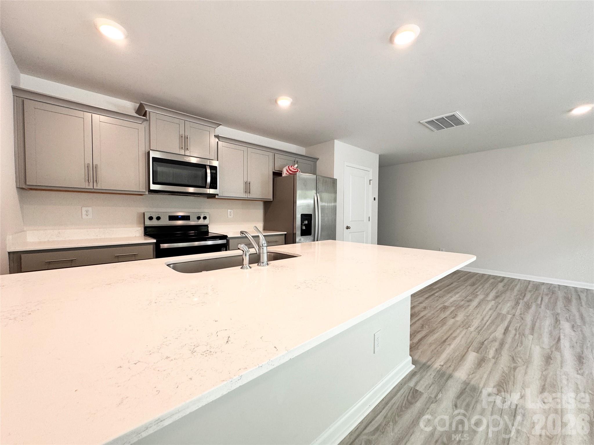 6131 Faron Way Charlotte, NC 28262 - Photo 1 of 18 a kitchen with stainless steel appliances a refrigerator sink and microwave