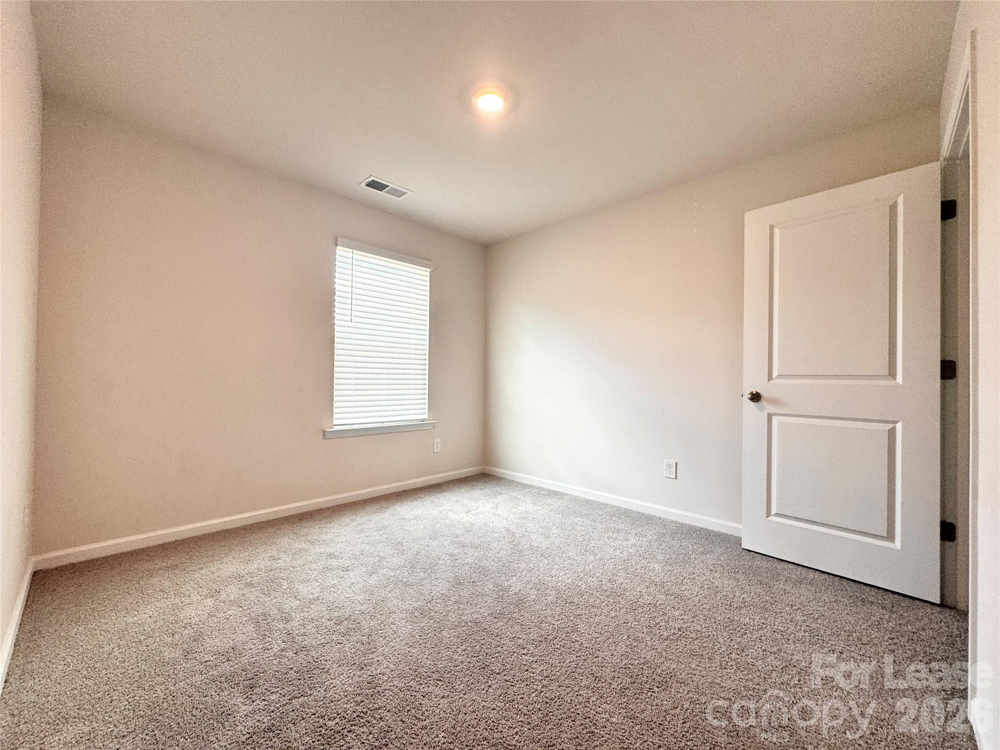 6131 Faron Way Charlotte, NC 28262 - Photo 11 of 18 an empty room with windows and closet