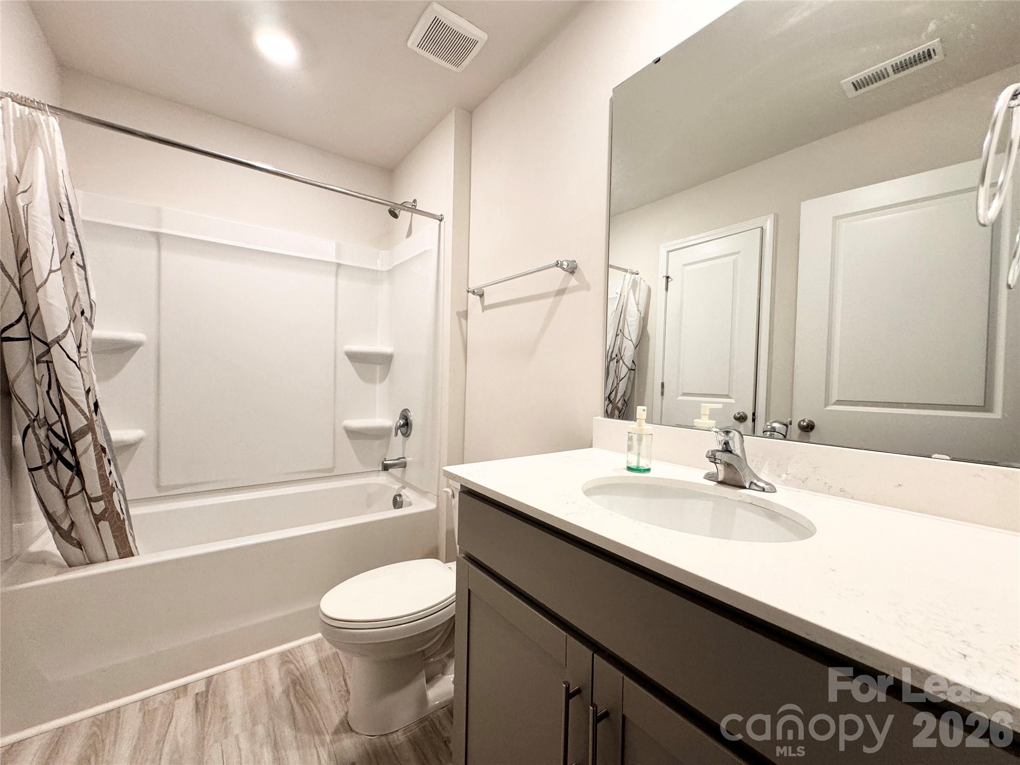 6131 Faron Way Charlotte, NC 28262 - Photo 12 of 18 a bathroom with a sink a toilet and a bathtub
