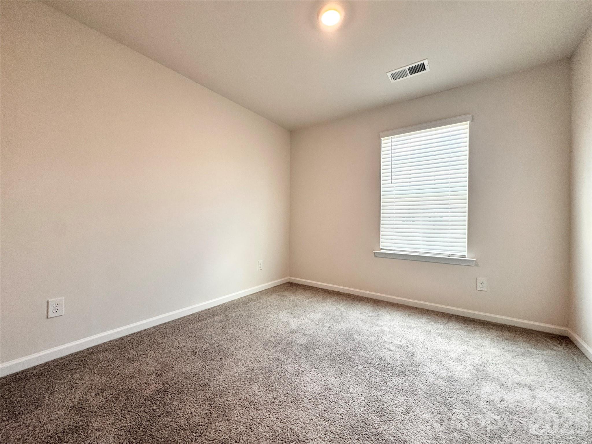 6131 Faron Way Charlotte, NC 28262 - Photo 13 of 18 an empty room with a window