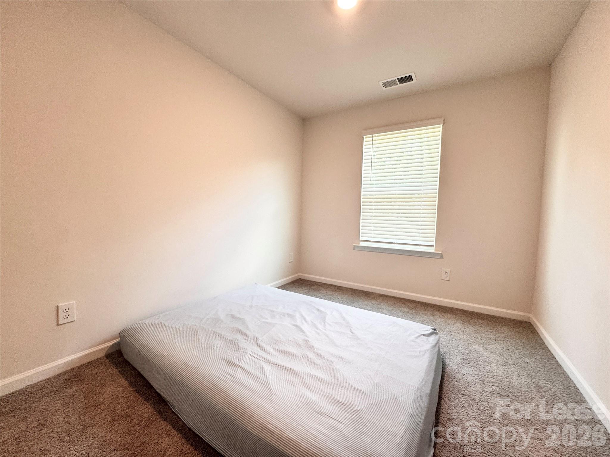 6131 Faron Way Charlotte, NC 28262 - Photo 15 of 18 a bedroom with a bed and a window