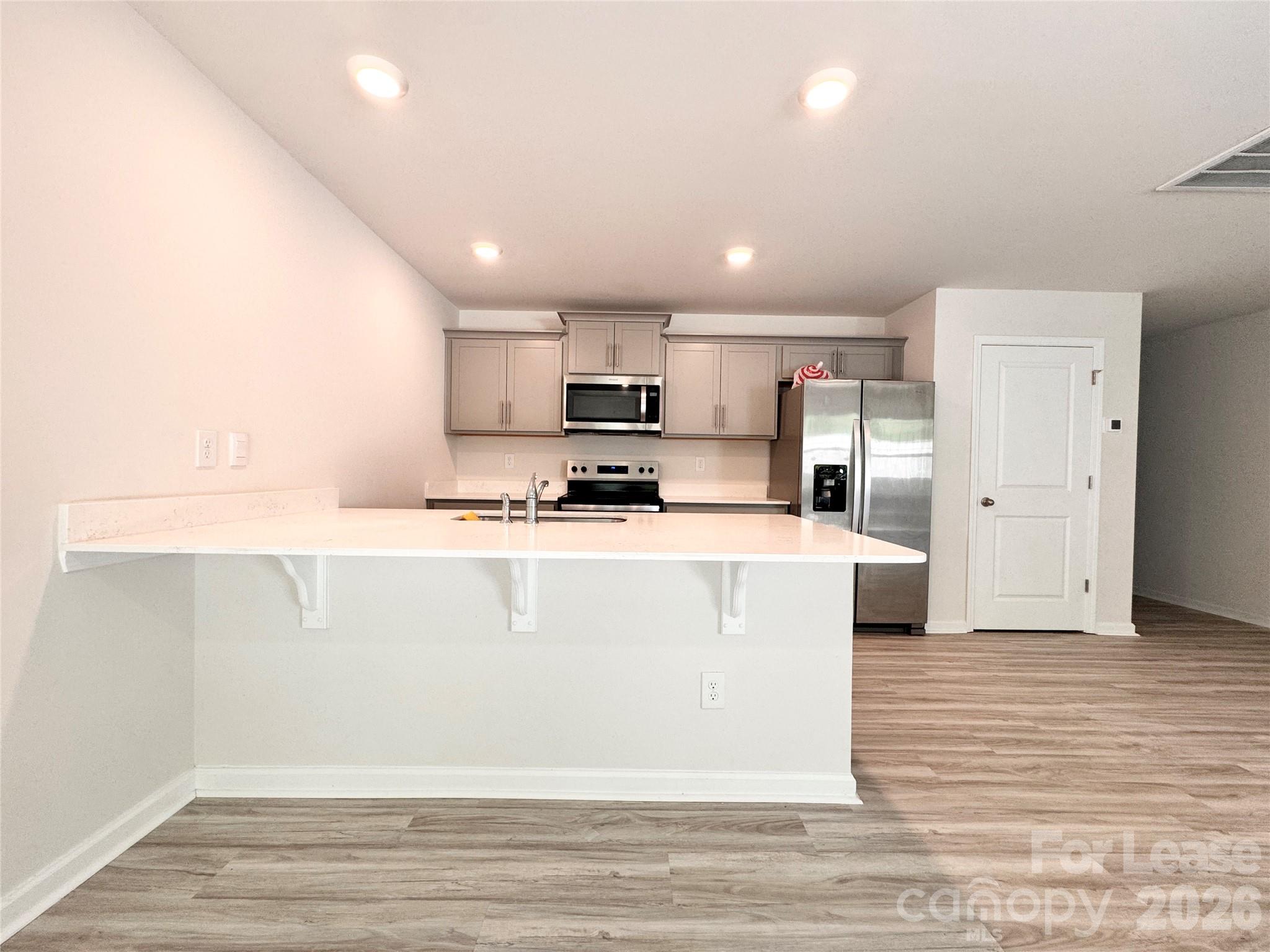 6131 Faron Way Charlotte, NC 28262 - Photo 2 of 18 a view of kitchen with stainless steel appliances granite countertop a stove a sink and a refrigerator