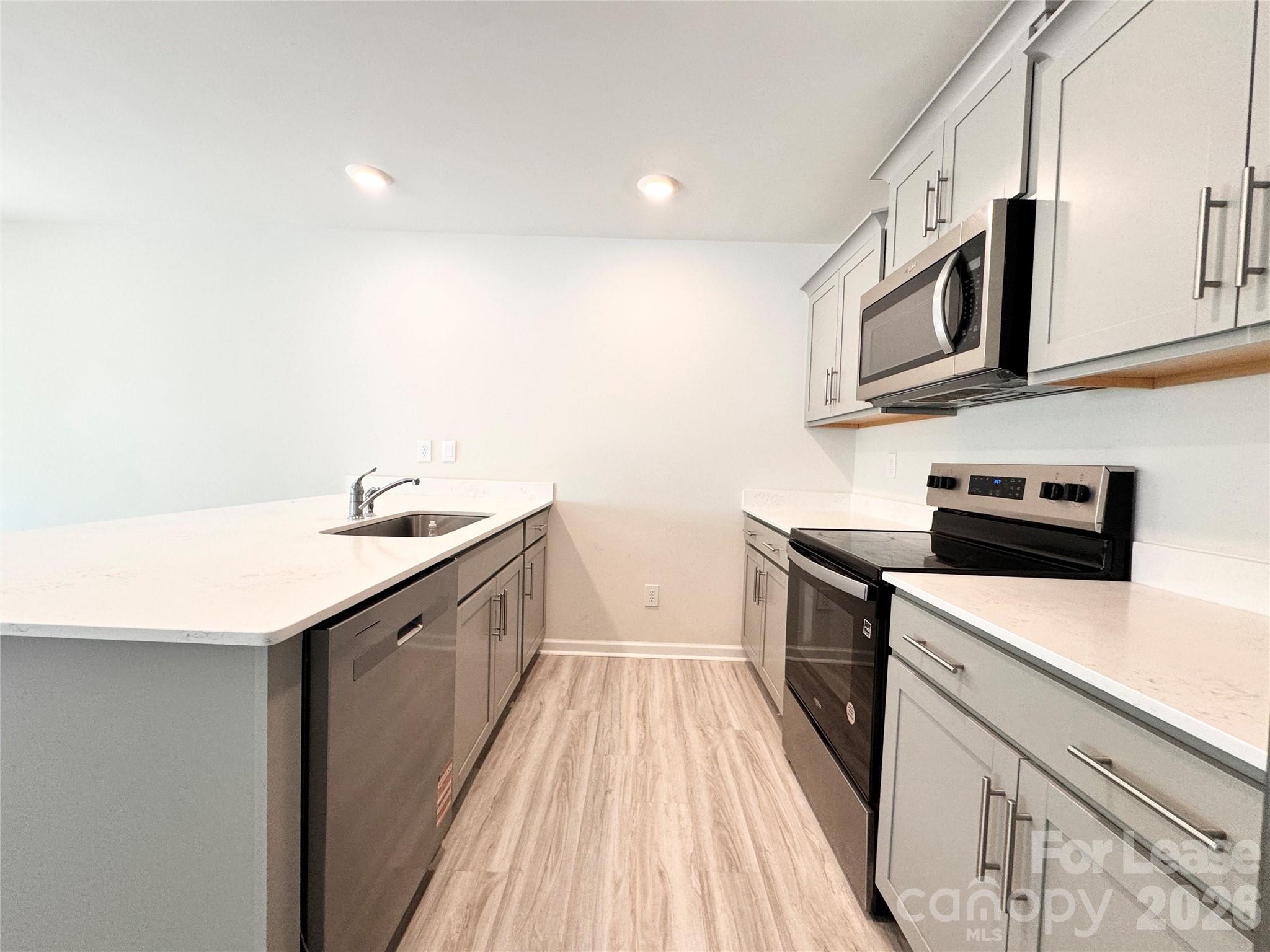 6131 Faron Way Charlotte, NC 28262 - Photo 4 of 18 a kitchen with stainless steel appliances granite countertop a sink and a stove