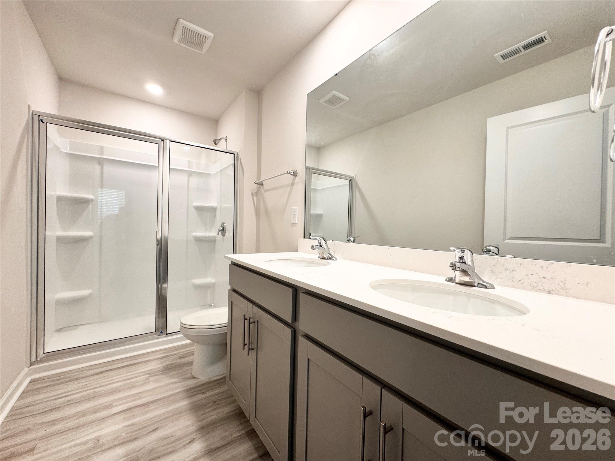 6131 Faron Way Charlotte, NC 28262 - Photo 10 of 18 a bathroom with a double vanity sink and mirror