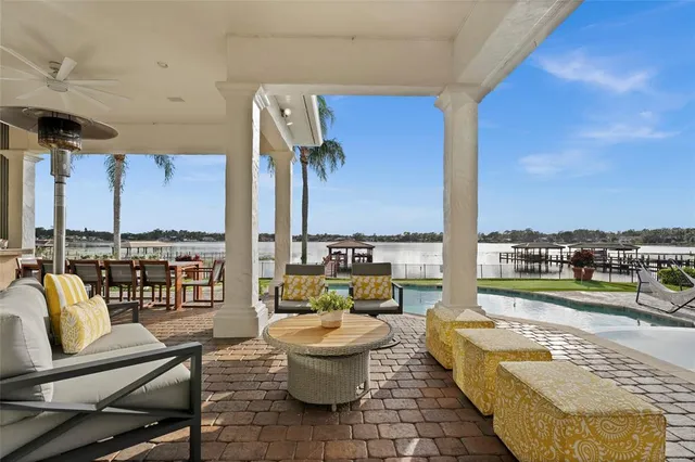 a view of a house with swimming pool and sitting area