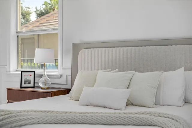 a bedroom with a large bed and a window