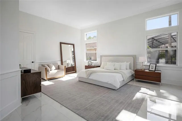 a large room with lots of white furniture