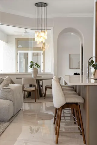 a bedroom with a bed and a potted plant on dresser