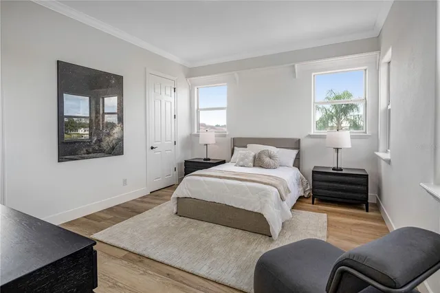 a bedroom with a bed couch and painting on the wall