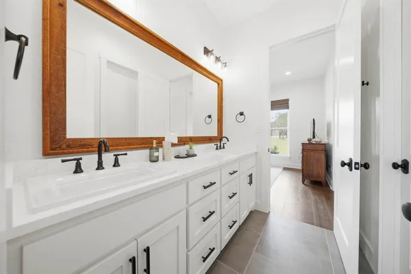 a bathroom with a double vanity sink and mirror