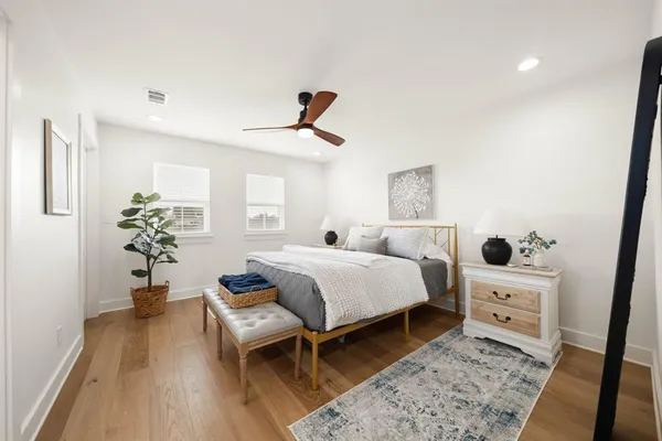 a bedroom with a bed and wooden floor