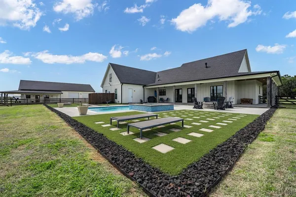 a view of house with swimming pool outdoor seating