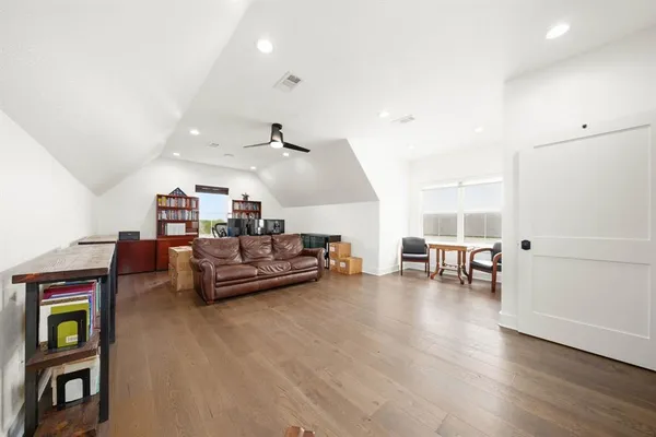 a living room with furniture and a table with wooden floor