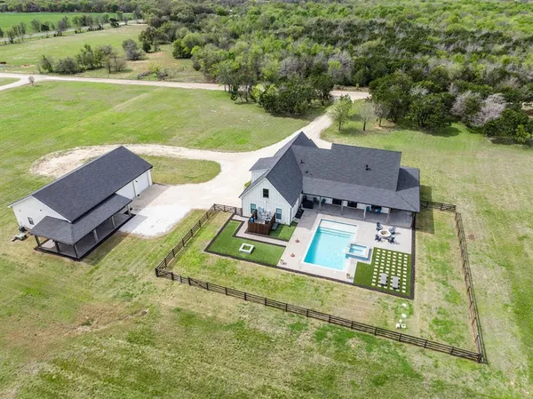 an aerial view of a house with garden space and street view