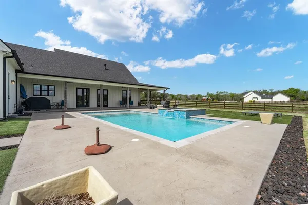 a view of a house with swimming pool and yard