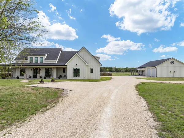 a front view of house with yard and lake