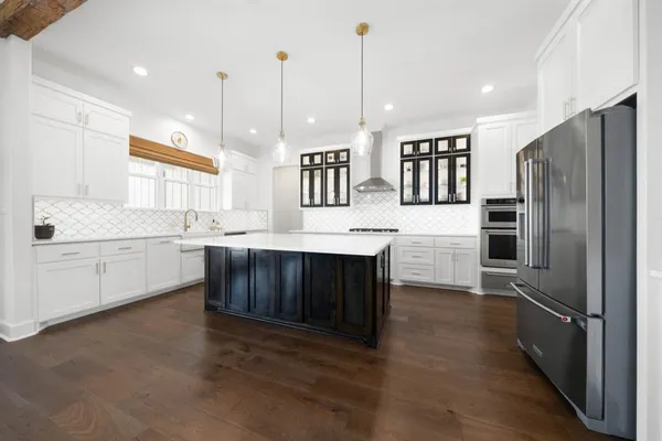 a kitchen with a sink stainless steel appliances and window