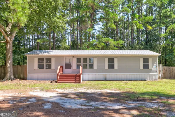 a front view of house with yard and trees