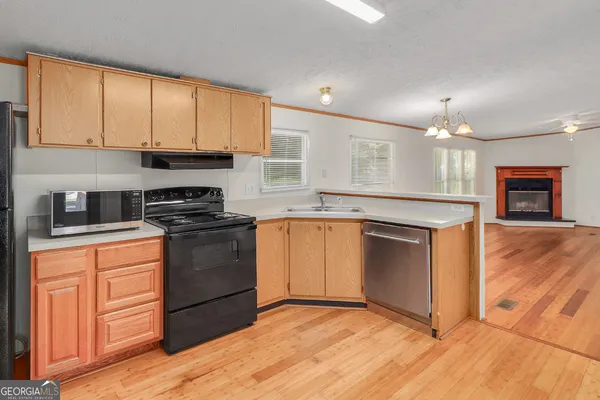 a kitchen with granite countertop a stove top oven sink and cabinets