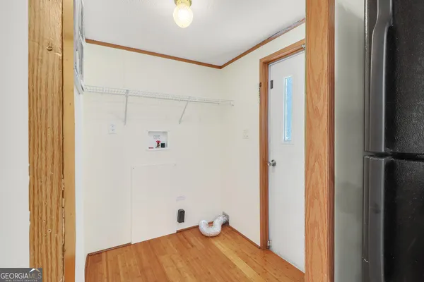a view of a room with wooden floor and closet