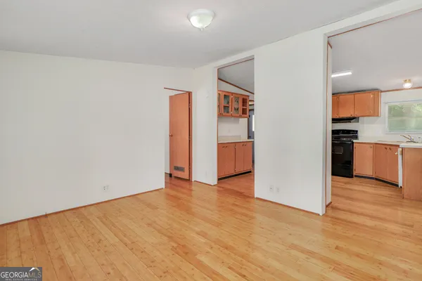 a view of a kitchen with a sink and a refrigerator