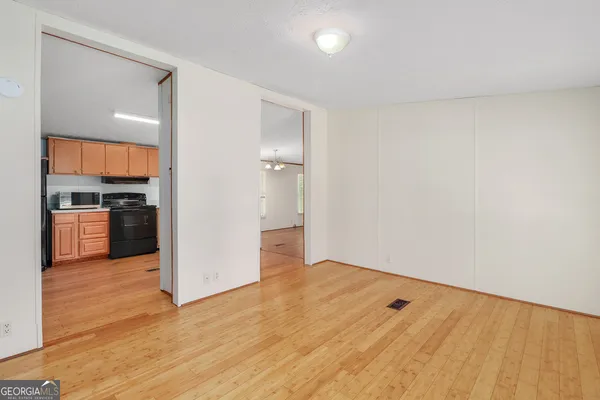 a view of a kitchen with a sink and a refrigerator