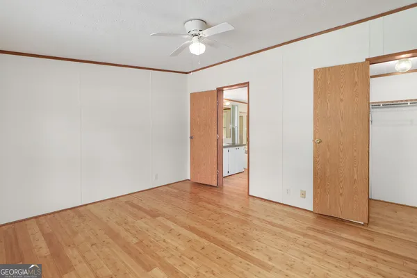 a view of an empty room with wooden floor