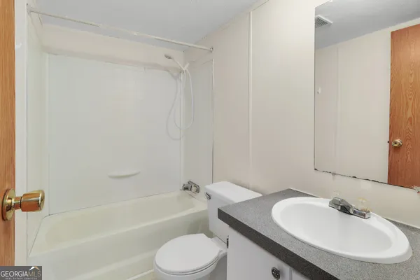 a bathroom with a toilet a sink and a bathtub