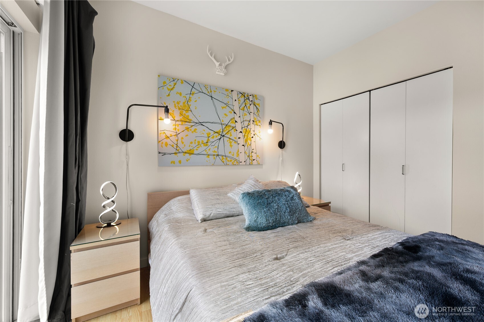 2415 2nd Avenue, Unit 540 Seattle, WA 98121 - Photo 14 of 29 a bedroom with a bed and a mirror