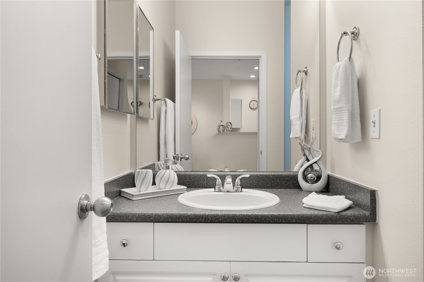 2415 2nd Avenue, Unit 540 Seattle, WA 98121 - Photo 16 of 29 a bathroom with a granite countertop sink and a mirror