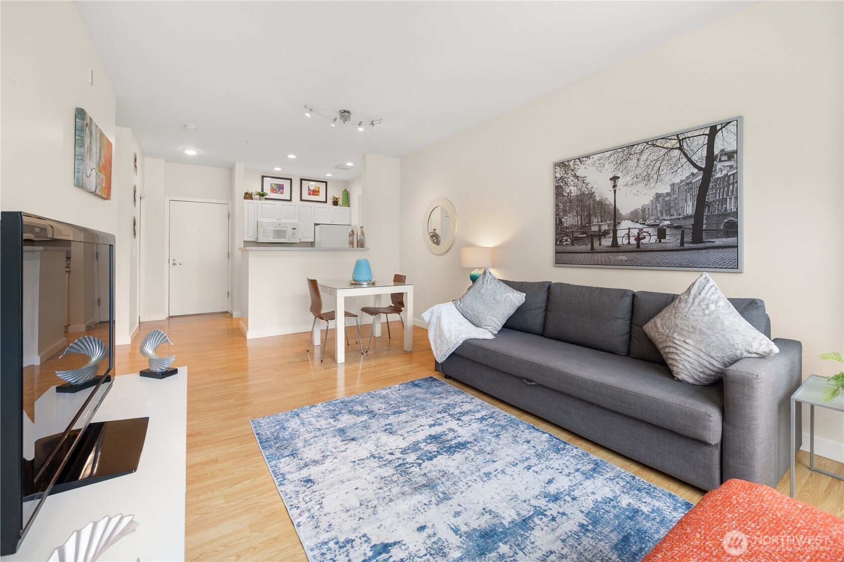 2415 2nd Avenue, Unit 540 Seattle, WA 98121 - Photo 2 of 29 a living room with furniture and a flat screen tv