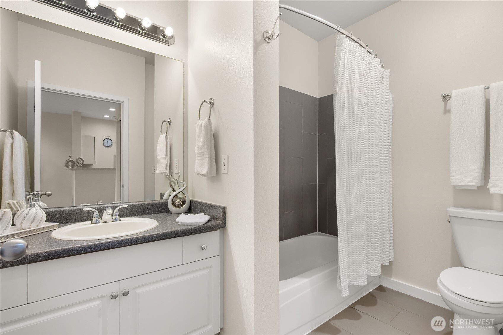 2415 2nd Avenue, Unit 540 Seattle, WA 98121 - Photo 7 of 29 a bathroom with a granite countertop sink toilet and shower