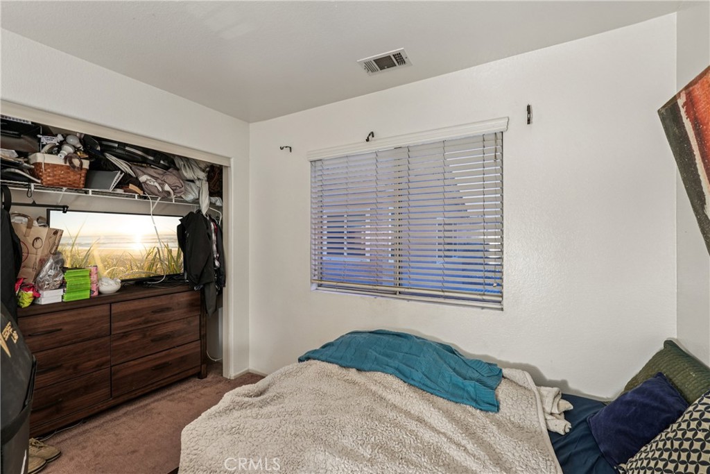 988 Cimarron Place Corona, CA 92879 - Photo 17 of 23 a bedroom with bed and a flat screen tv