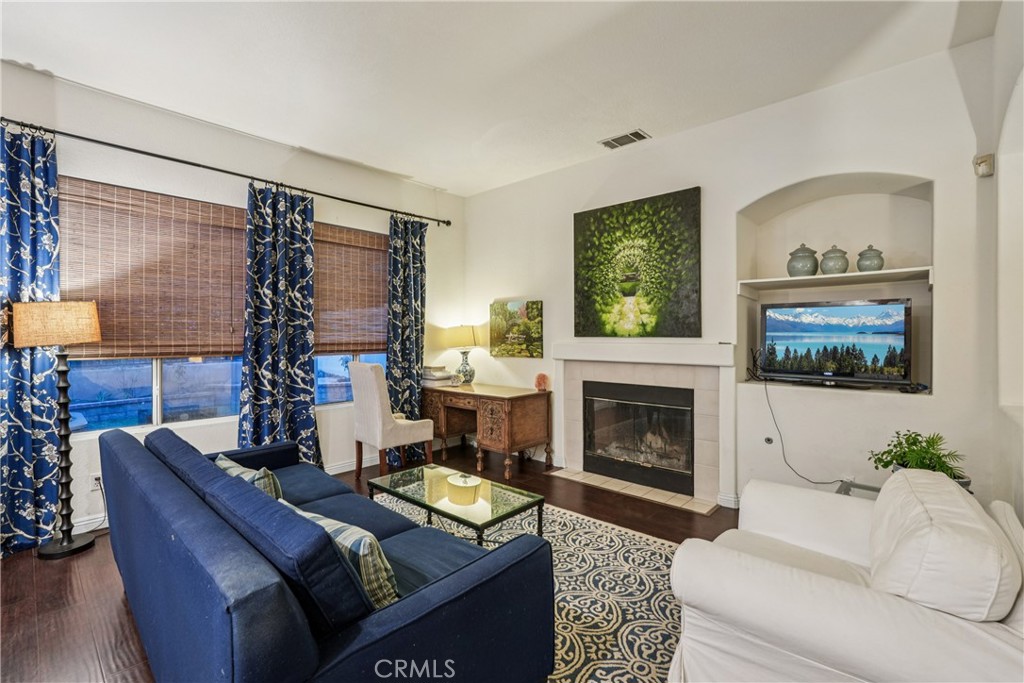 988 Cimarron Place Corona, CA 92879 - Photo 3 of 23 a living room with furniture fireplace and flat screen tv