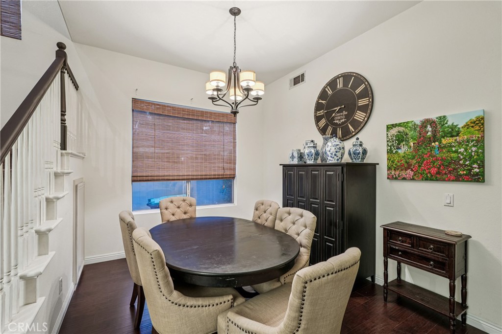 988 Cimarron Place Corona, CA 92879 - Photo 5 of 23 a view of a dining room with furniture wooden floor and a chandelier