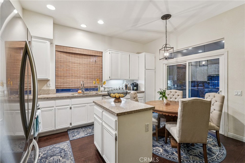 988 Cimarron Place Corona, CA 92879 - Photo 9 of 23 a kitchen with a sink stove and refrigerator