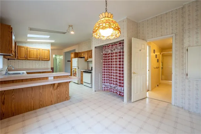 a view of a kitchen with a sink and a refrigerator