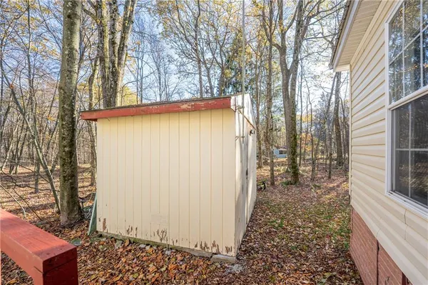 a view of a house with a yard and sitting area