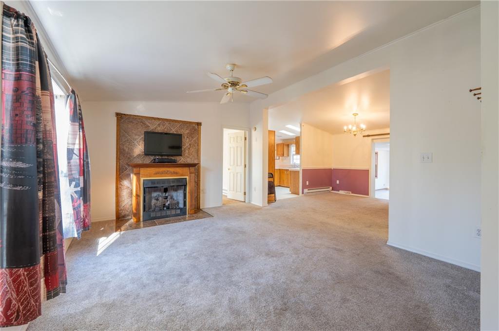 402 Ridgeview Road Boswell, PA 15531 - Photo 6 of 32 a view of an empty room with a fireplace and a window