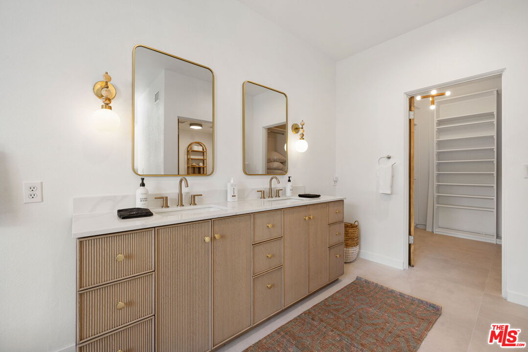 1414 Sagebrush Road Palm Springs, CA 92264 - Photo 27 of 48 a bathroom with a double vanity sink and mirror