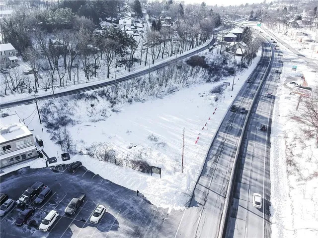 a view of a yard with a wooden fence