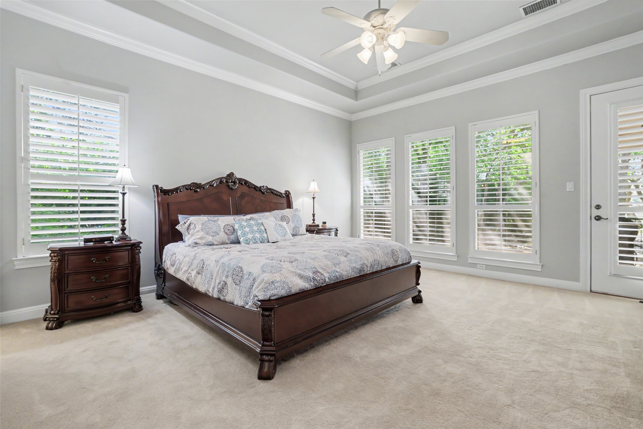 33 Meadows End Georgetown, TX 78628 - Photo 17 of 40 Elegant crown molding and a tray ceiling add architectural depth to this naturally illuminated primary suite.