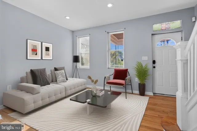 a living room with furniture and wooden floor