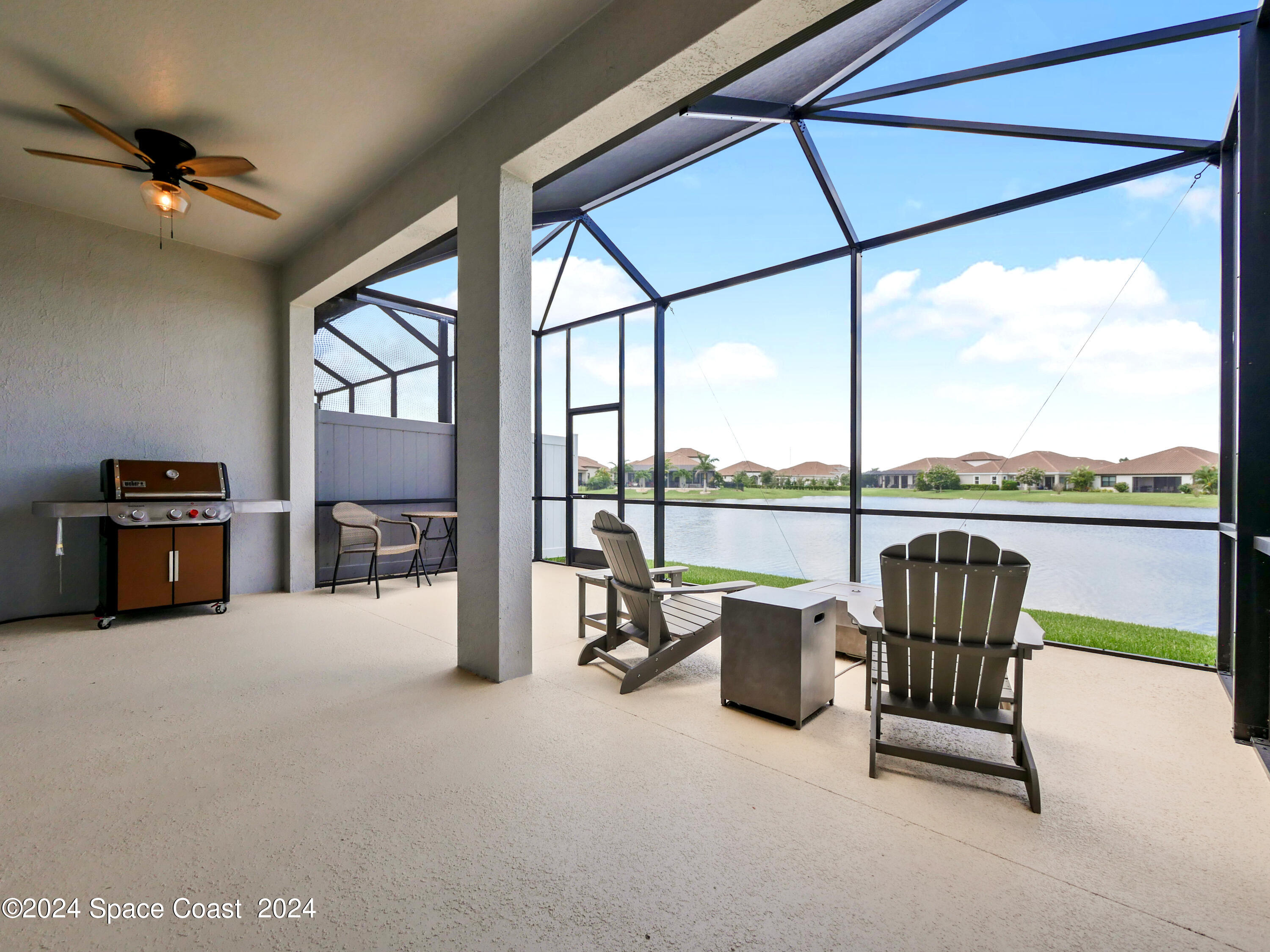 3149 Avalonia Drive Melbourne, FL 32940 - Photo 27 of 31 a living room with furniture and a floor to ceiling window