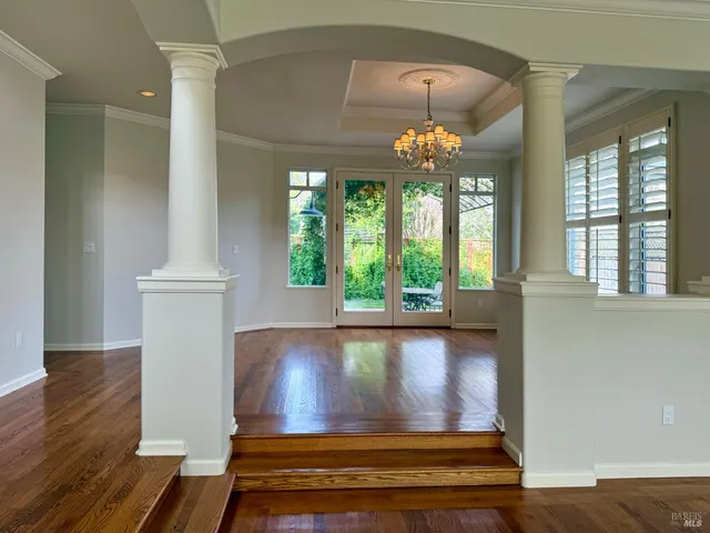 a living room with furniture and a chandelier