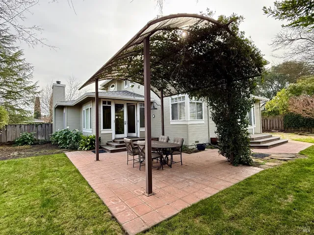 a view of a house with backyard porch and sitting area