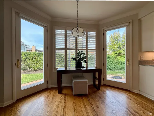 a kitchen with a refrigerator stove and wooden floor