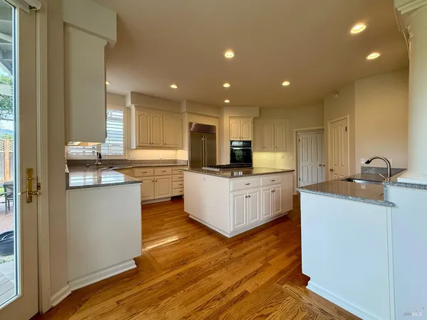 a kitchen with a stove a sink and a window