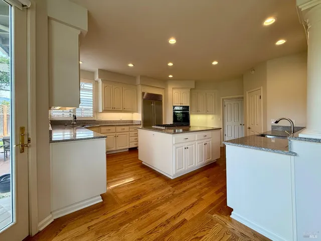 a kitchen with a stove a sink and a window
